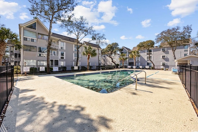 view of pool featuring a residential view and fence