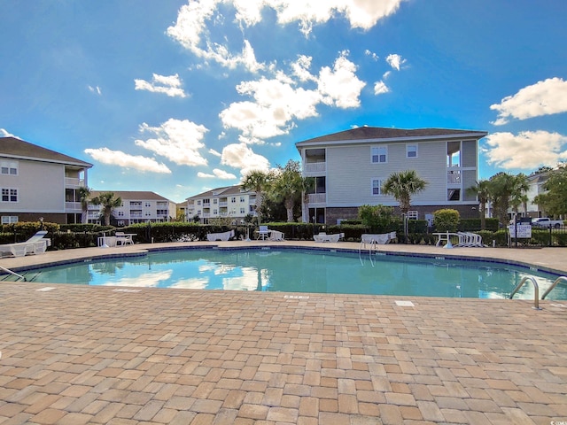 pool featuring a patio area and fence