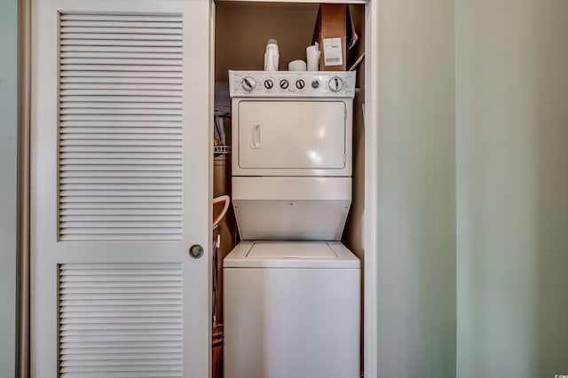 laundry area featuring laundry area and stacked washer / drying machine