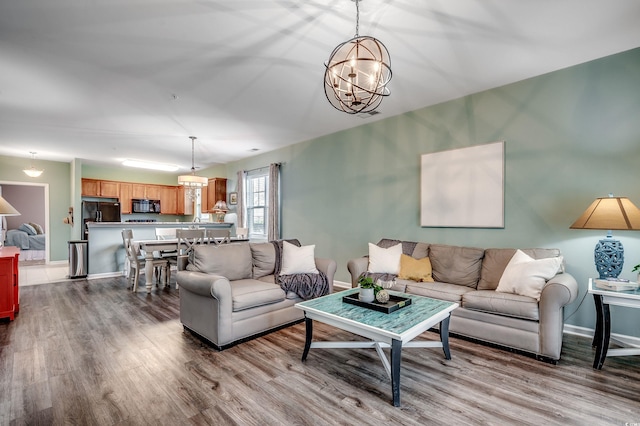 living area with light wood-type flooring and baseboards