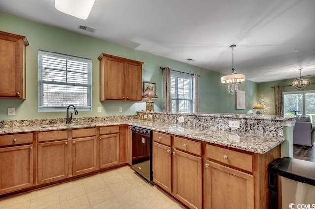 kitchen featuring a peninsula, a sink, visible vents, black dishwasher, and brown cabinetry