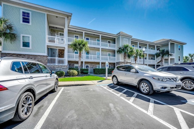 uncovered parking lot featuring a residential view