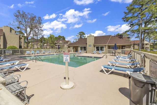 pool featuring a patio and fence