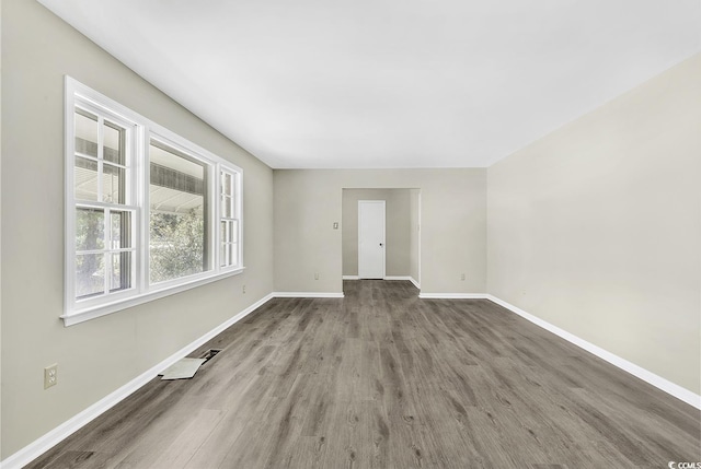 unfurnished room featuring wood finished floors and baseboards