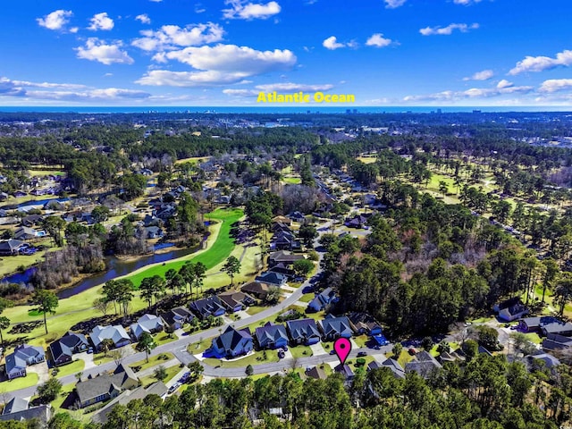 drone / aerial view featuring a water view, a residential view, and golf course view