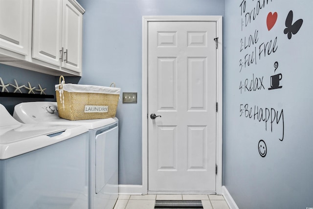 laundry room featuring cabinet space, independent washer and dryer, baseboards, and tile patterned floors