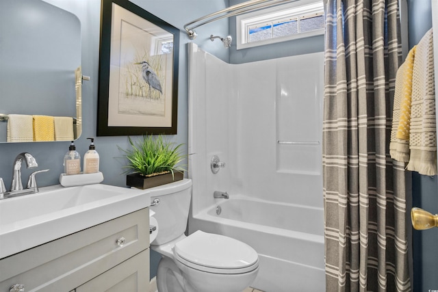 bathroom featuring toilet, shower / bath combo, and vanity