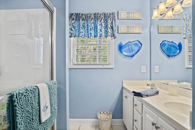 bathroom with double vanity, tile patterned flooring, baseboards, and a sink