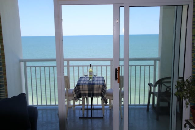 sunroom / solarium with a water view