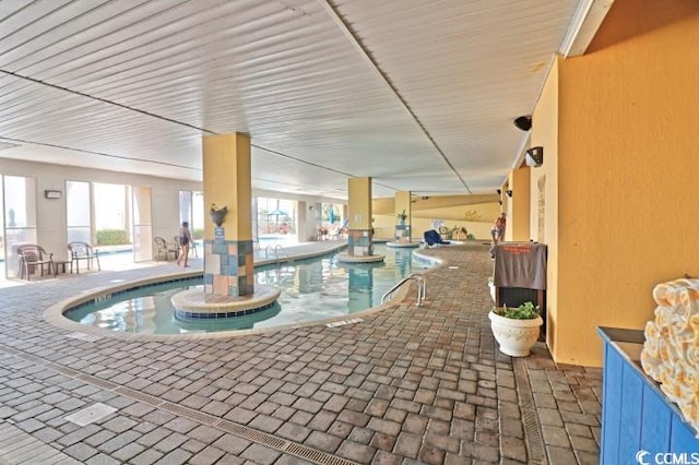 community pool featuring an indoor hot tub