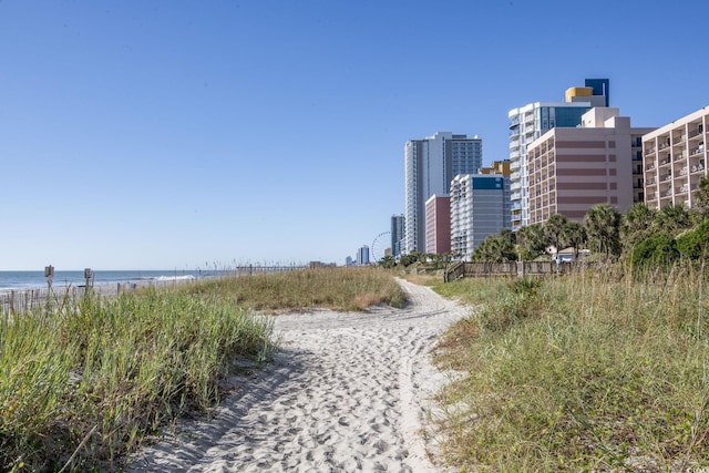 view of community featuring a water view, a city view, and a view of the beach