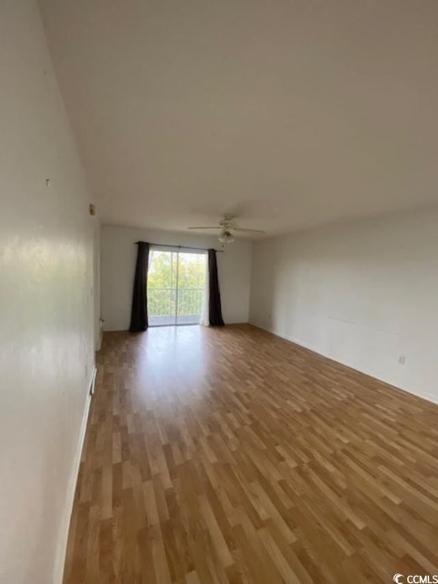 unfurnished room with ceiling fan and light wood-style flooring