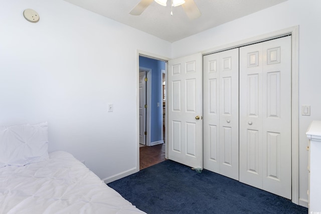 unfurnished bedroom with ceiling fan, a closet, carpet, and baseboards