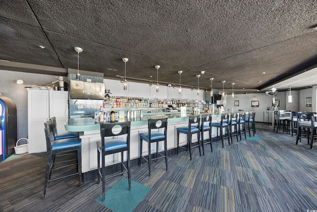 kitchen featuring hanging light fixtures and carpet