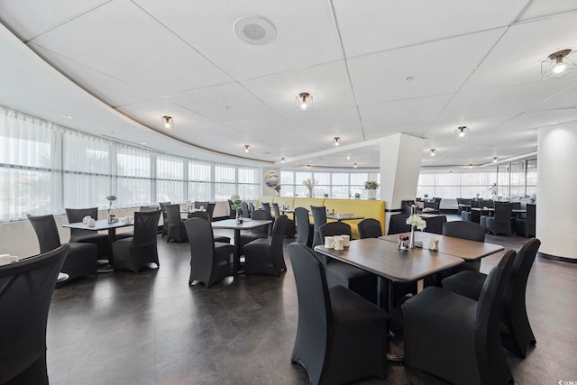 dining room featuring a drop ceiling