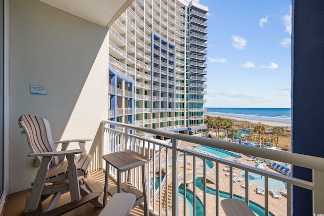 balcony with a water view and a beach view