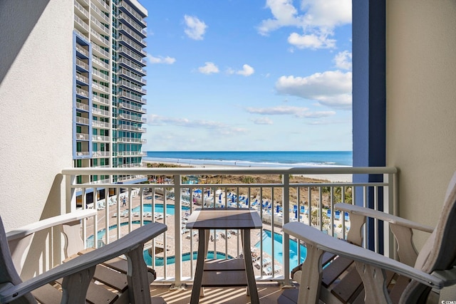 balcony featuring a water view and a view of the beach