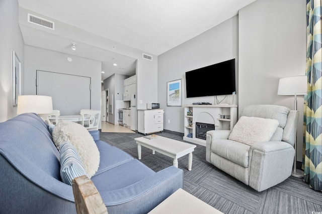 living area featuring visible vents and baseboards