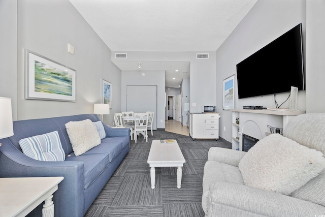 living room with visible vents and carpet flooring