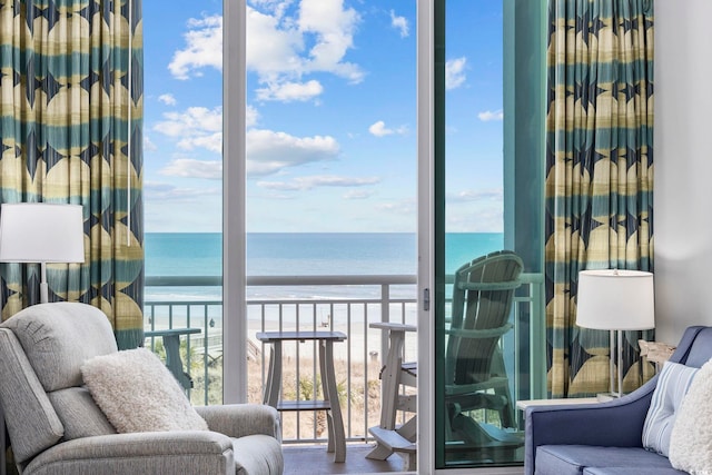 balcony with a water view and a beach view