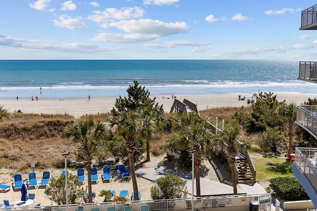 view of water feature with stairs and a view of the beach