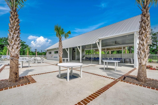 view of patio with ceiling fan, fence, and outdoor dining space