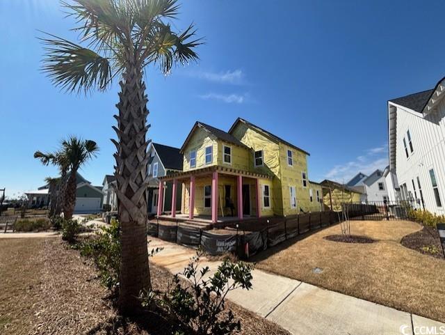view of side of home featuring fence