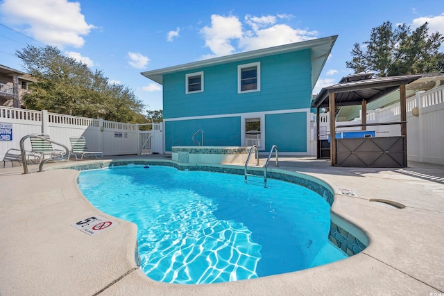 pool featuring a patio, a gazebo, fence, and a jacuzzi