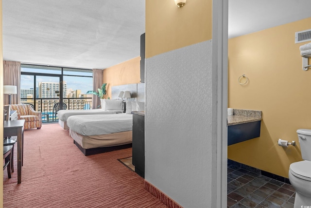 1501 S Ocean Blvd Unit 1005, Myrtle Beach, SC 29577 - carpeted bedroom with visible vents, access to exterior, and a wall of windows