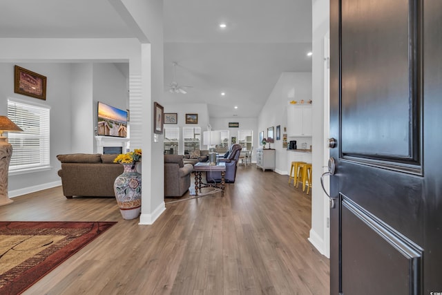 entrance foyer with a fireplace, recessed lighting, ceiling fan, wood finished floors, and baseboards