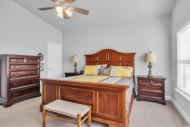 bedroom featuring lofted ceiling, ceiling fan, baseboards, and light colored carpet