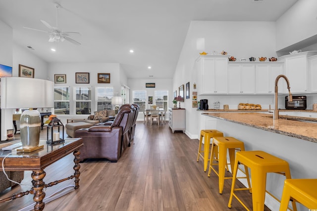 living room featuring visible vents, ceiling fan, wood finished floors, high vaulted ceiling, and recessed lighting