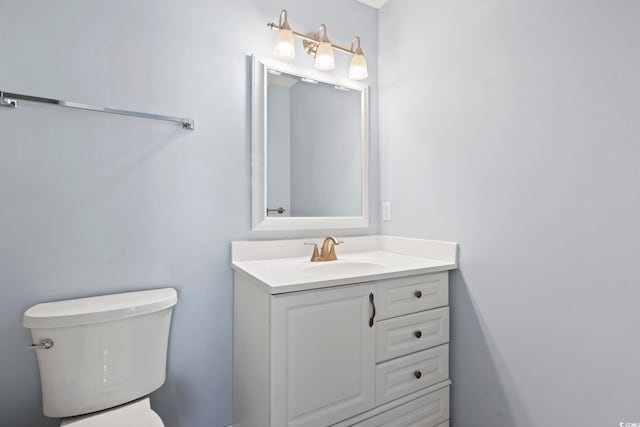 bathroom featuring toilet and vanity