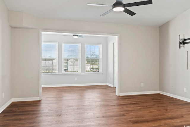 unfurnished room with baseboards, a ceiling fan, and wood finished floors