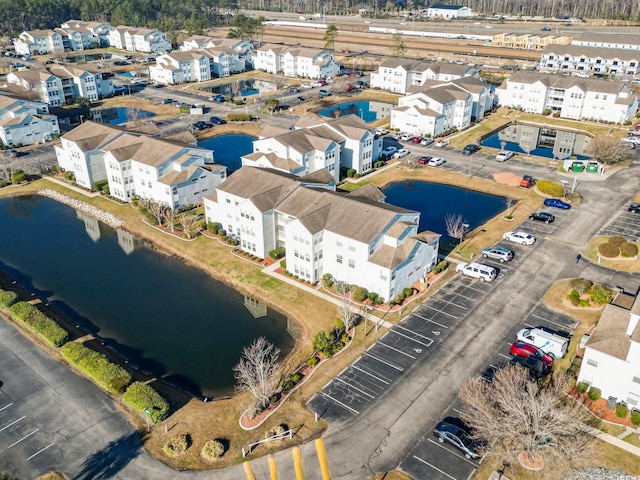 drone / aerial view featuring a water view and a residential view