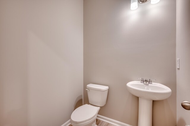 179 Glengrove Ln, Murrells Inlet, SC 29576 - half bathroom with baseboards, toilet, and a sink