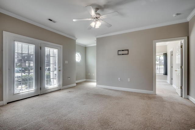 spare room featuring light carpet, baseboards, and a wealth of natural light