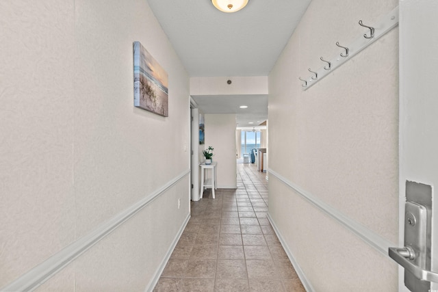 hall with light tile patterned floors