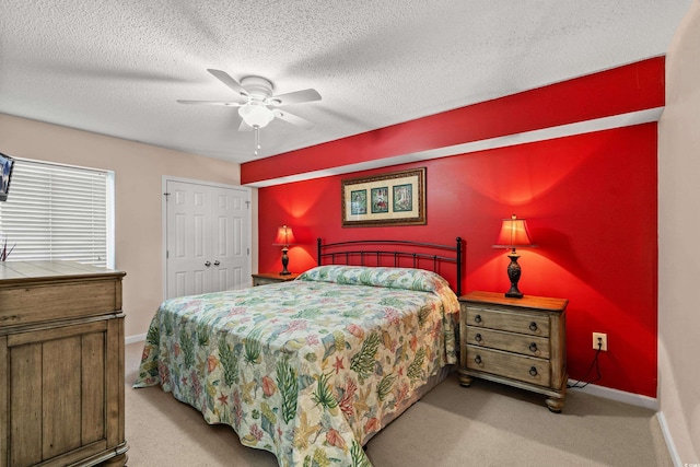 bedroom with carpet, ceiling fan, a textured ceiling, and baseboards