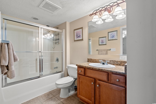 full bathroom featuring visible vents, toilet, vanity, a textured ceiling, and tile patterned floors