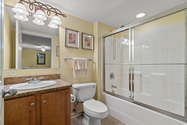 bathroom featuring shower / bath combination with glass door, toilet, a textured ceiling, vanity, and tile patterned flooring