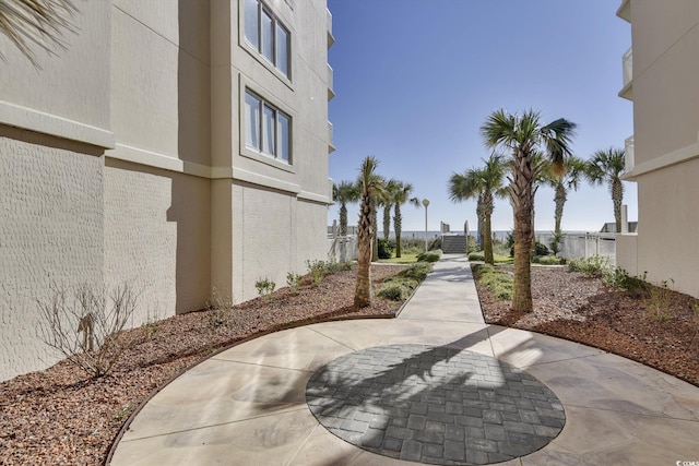 surrounding community with fence and a patio