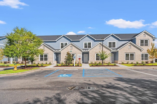 view of building exterior featuring uncovered parking