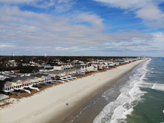 birds eye view of property featuring a beach view and a water view