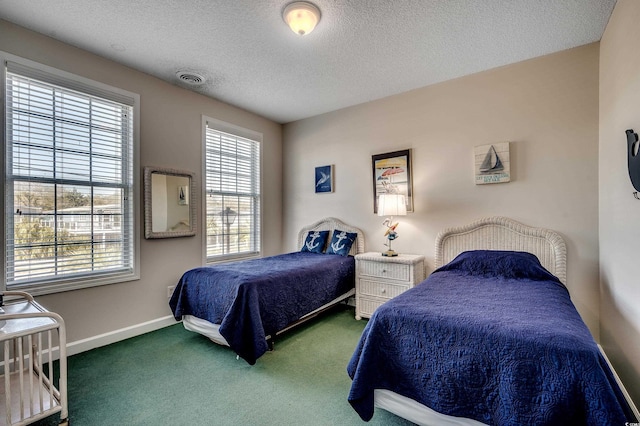 bedroom featuring carpet floors, visible vents, a textured ceiling, and baseboards