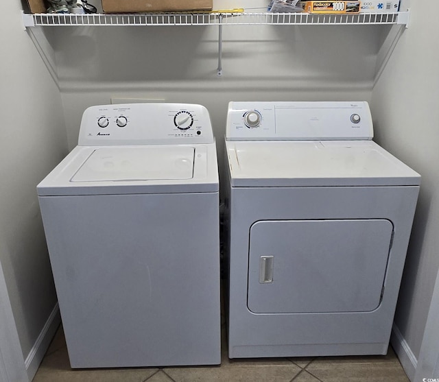 washroom with baseboards, laundry area, and washer and dryer