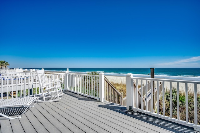 deck featuring a water view and a beach view