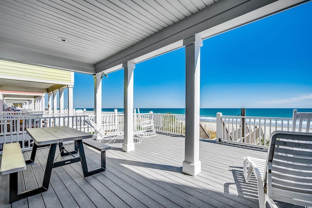 wooden terrace with a water view and a beach view