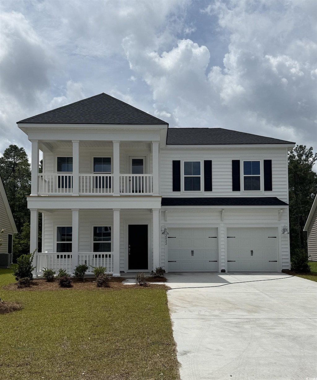 2022 Lone Cypress Dr, Myrtle Beach, SC 29579 - neoclassical / greek revival house featuring covered porch, a garage, driveway, a front yard, and a balcony