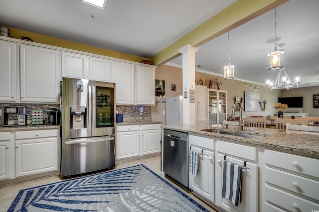 kitchen with white cabinetry, a sink, backsplash, and stainless steel appliances